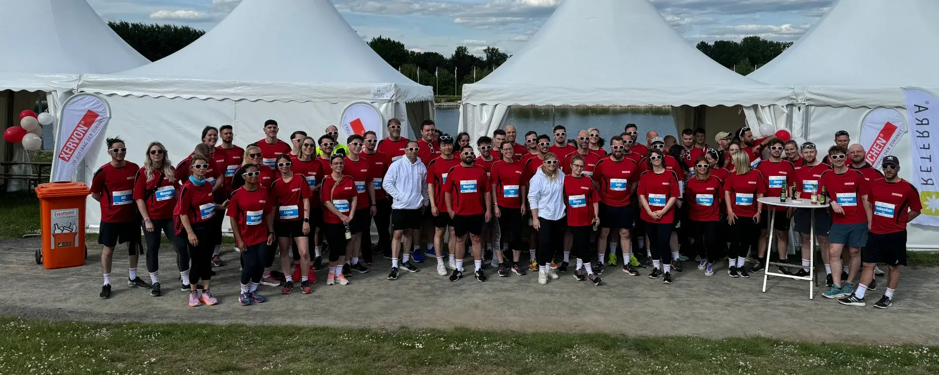 Gruppenbild der Mitarbeiter aus den RMS-Gesellschaften in roten Firmentrikots nach dem Firmenlauf.